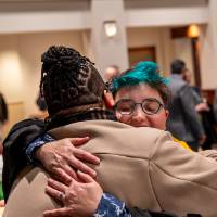 faculty sharing a warm embrace